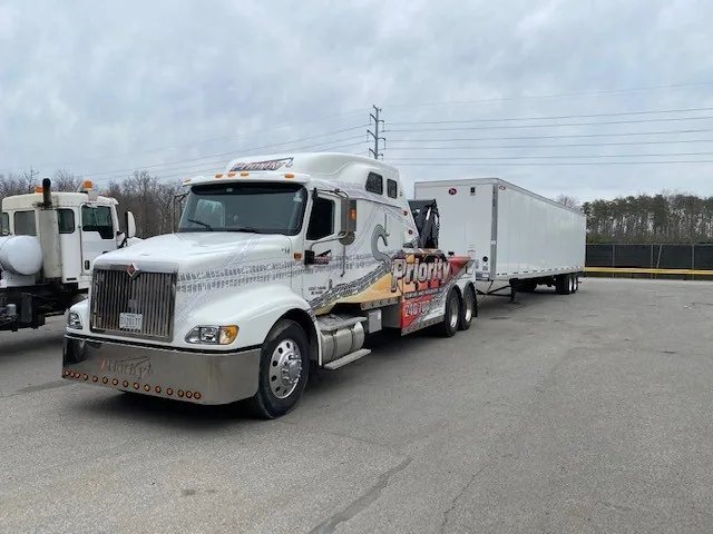 Priority Towing tractor hauling an enclosed trailer